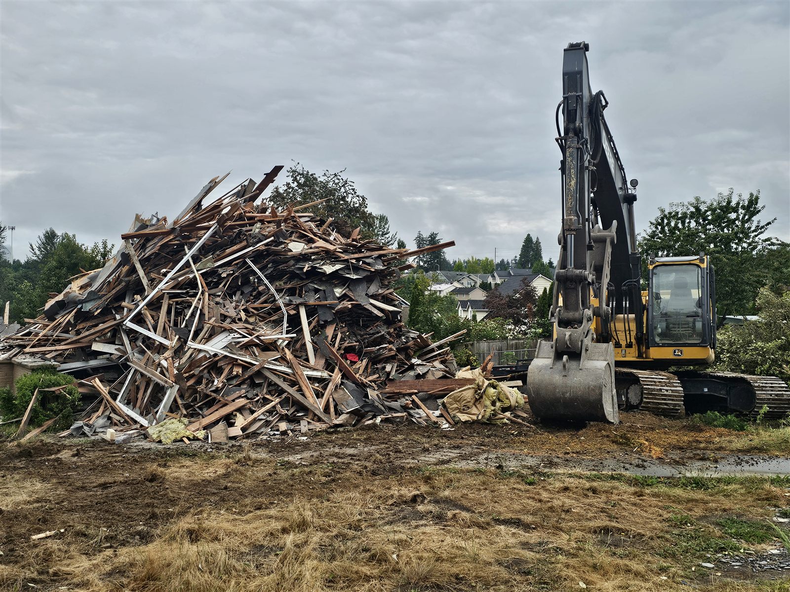 Excavator working a demolition debris pile
